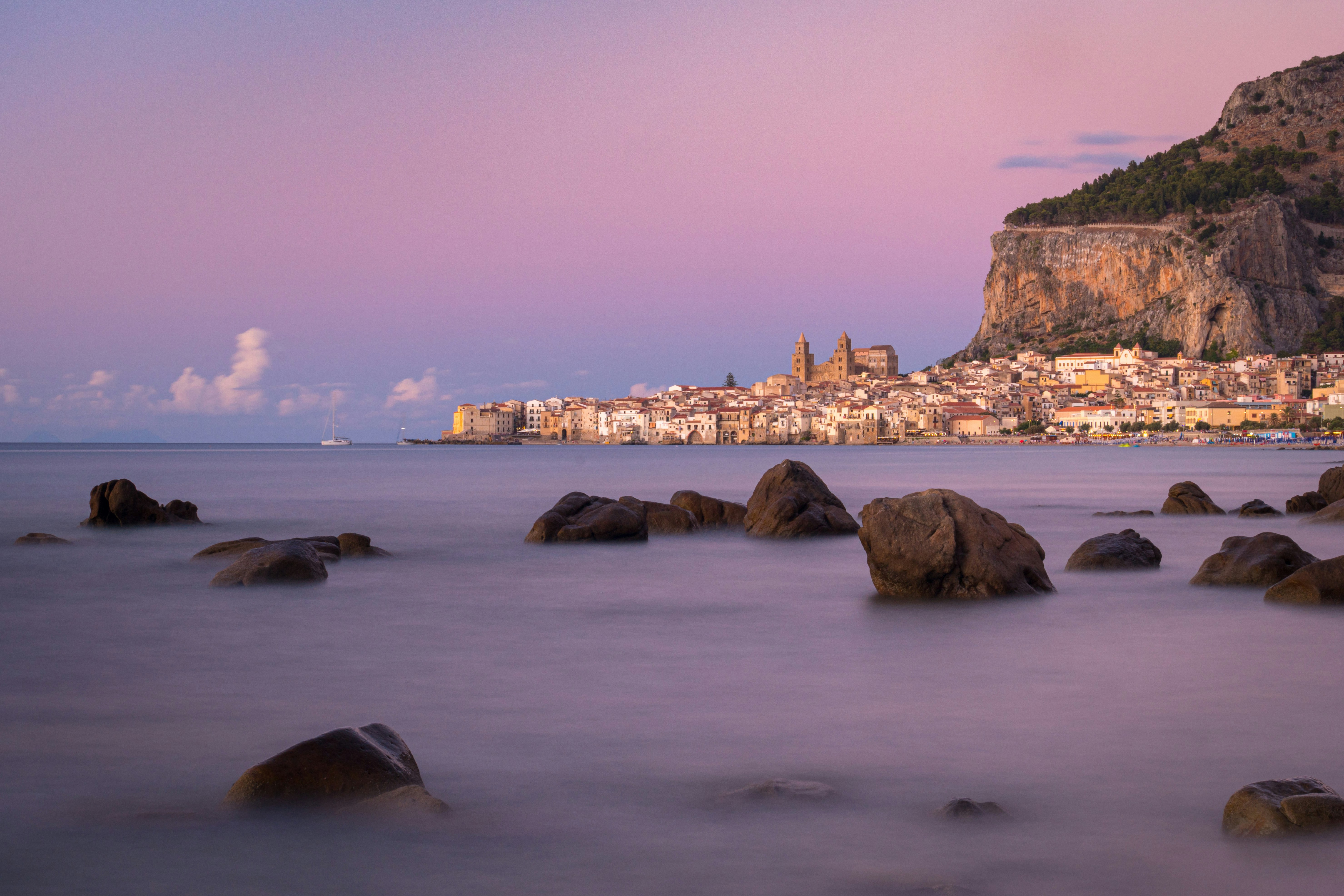 brown rock formation on sea during daytime